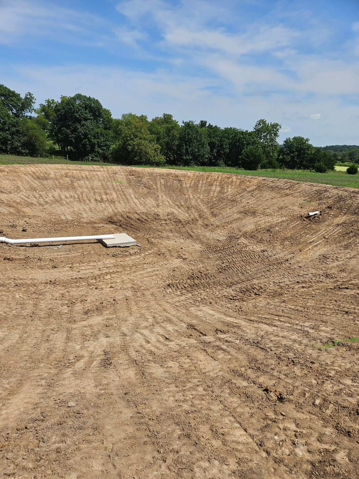 A newly excavated lagoon system installed on a rural Northwest Missouri property