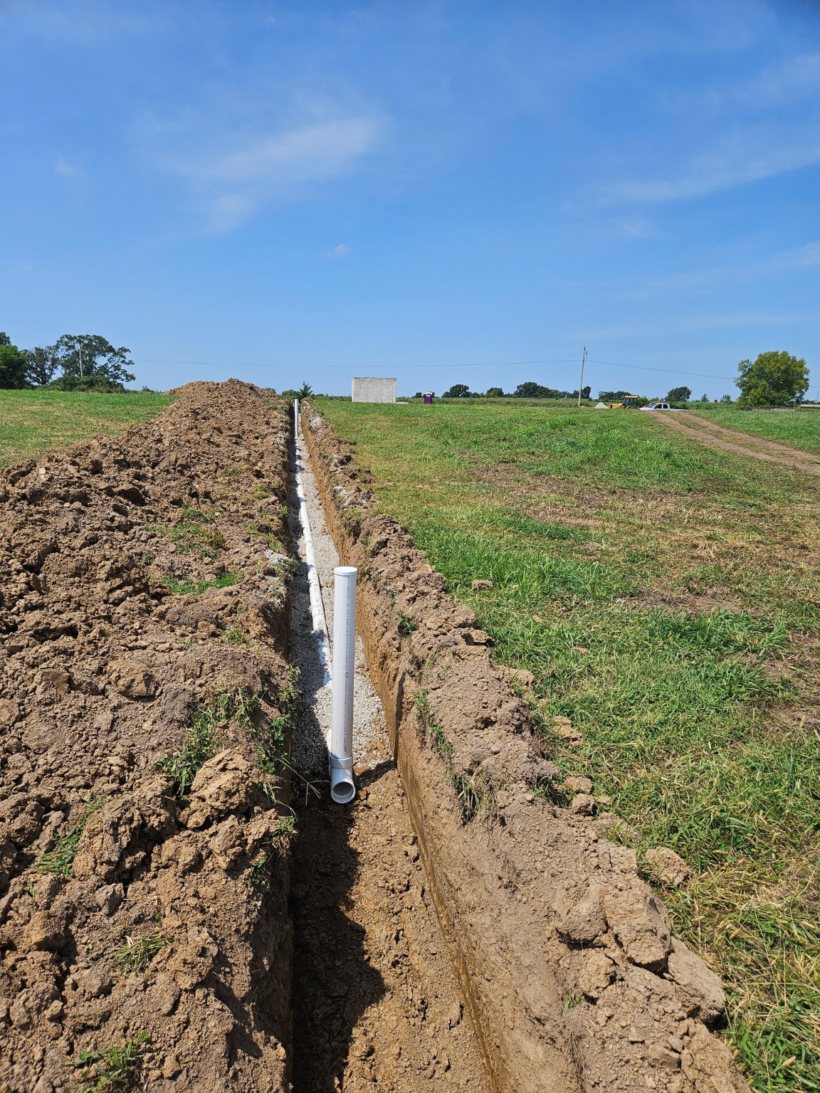 A new septic-to-lagoon line installed in a gravel-lined trench